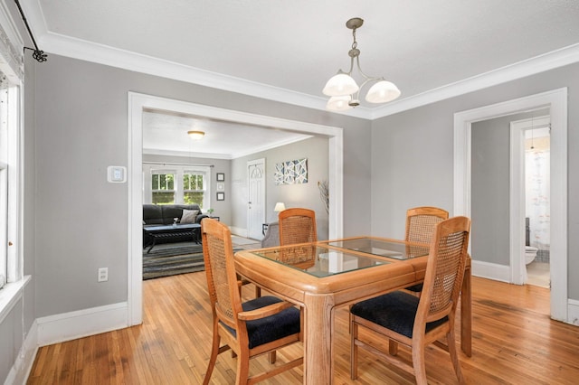 4027 24th Ave S, Minneapolis, MN 55406 - dining area featuring ornamental molding, light wood finished floors, baseboards, and a chandelier