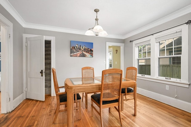 4027 24th Ave S, Minneapolis, MN 55406 - dining area featuring light wood-style floors, baseboards, and crown molding