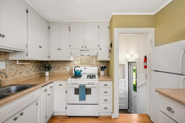 4027 24th Ave S, Minneapolis, MN 55406 - kitchen with white appliances, under cabinet range hood, white cabinets, backsplash, and ornamental molding