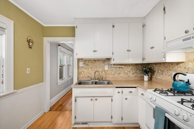 4027 24th Ave S, Minneapolis, MN 55406 - kitchen featuring a sink, white gas range oven, custom range hood, light countertops, and white cabinetry