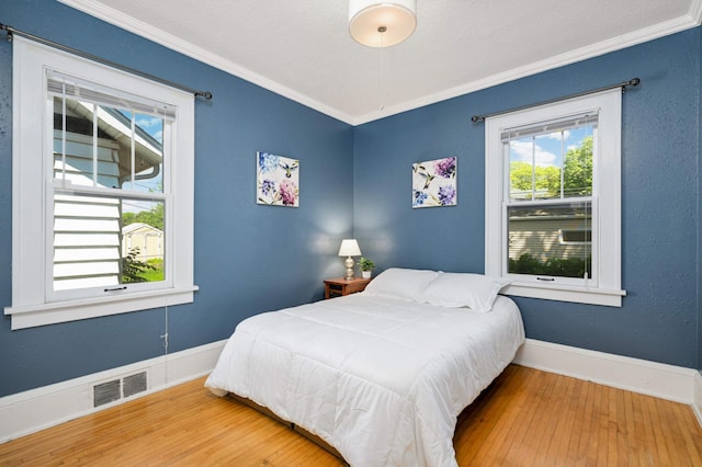 4027 24th Ave S, Minneapolis, MN 55406 - bedroom featuring ornamental molding, hardwood / wood-style floors, and baseboards