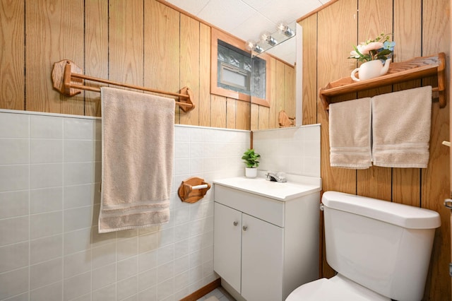 4027 24th Ave S, Minneapolis, MN 55406 - bathroom with vanity, toilet, wooden walls, and tile walls