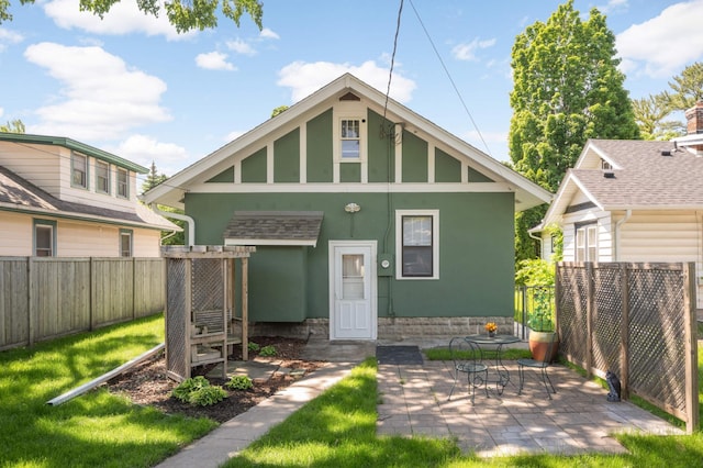 4027 24th Ave S, Minneapolis, MN 55406 - back of house featuring stucco siding and a patio