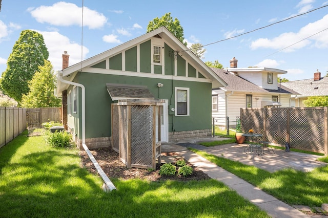 4027 24th Ave S, Minneapolis, MN 55406 - rear view of house featuring a chimney, stucco siding, and a patio