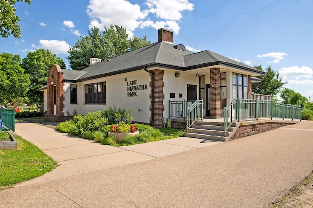 4027 24th Ave S, Minneapolis, MN 55406 - view of front of home with a chimney, brick siding, a porch, and a shingled roof