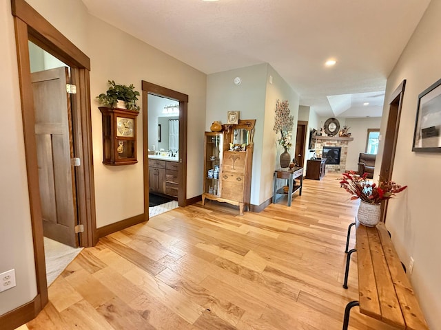 910 Lake Forest Cir, Detroit Lakes, MN 56501 - corridor with light wood-type flooring, baseboards, and a sink