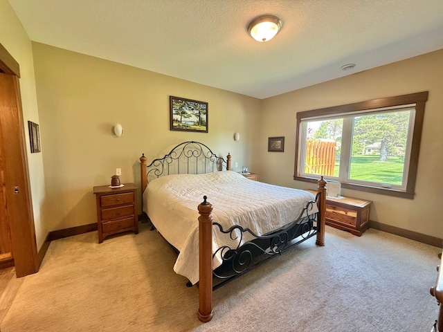 910 Lake Forest Cir, Detroit Lakes, MN 56501 - bedroom with light carpet, baseboards, and a textured ceiling