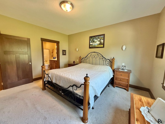 910 Lake Forest Cir, Detroit Lakes, MN 56501 - bedroom featuring light carpet, baseboards, and ensuite bath
