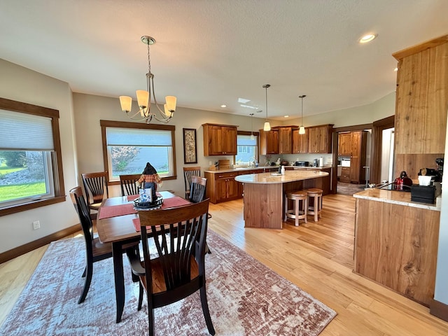 910 Lake Forest Cir, Detroit Lakes, MN 56501 - dining area featuring a chandelier, recessed lighting, light wood-style flooring, and baseboards