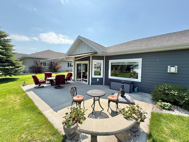 910 Lake Forest Cir, Detroit Lakes, MN 56501 - back of property featuring a patio area, board and batten siding, and a lawn