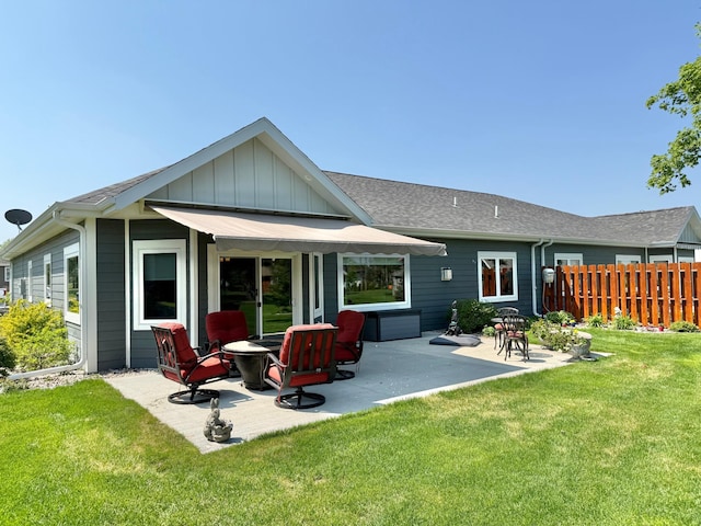 910 Lake Forest Cir, Detroit Lakes, MN 56501 - back of property featuring a patio, board and batten siding, and a shingled roof