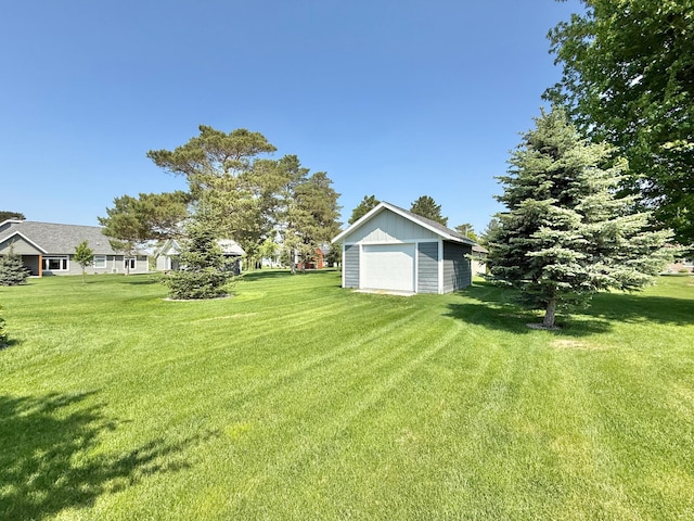 910 Lake Forest Cir, Detroit Lakes, MN 56501 - view of grassy yard featuring a garage and an outbuilding
