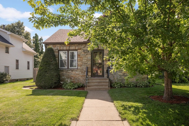 3638 Van Buren St NE, Minneapolis, MN 55418 - view of front of house featuring stone siding, a front yard, and roof with shingles