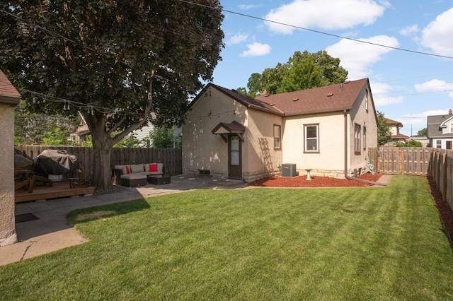 3638 Van Buren St NE, Minneapolis, MN 55418 - rear view of house featuring a fenced backyard, outdoor lounge area, stucco siding, a wooden deck, and a patio