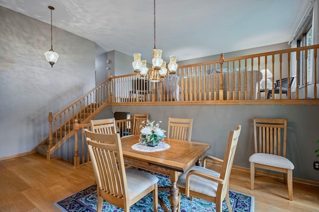 4781 Zealand Ave N, New Hope, MN 55428 - dining space with wood finished floors, a chandelier, and stairway