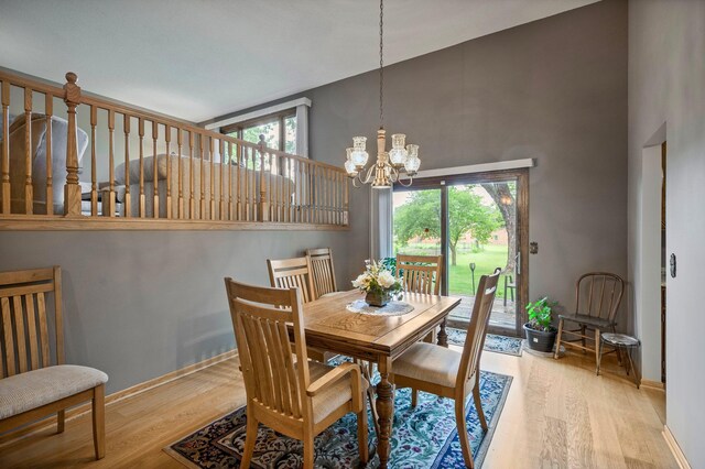 4781 Zealand Ave N, New Hope, MN 55428 - dining area featuring high vaulted ceiling, wood finished floors, and a chandelier