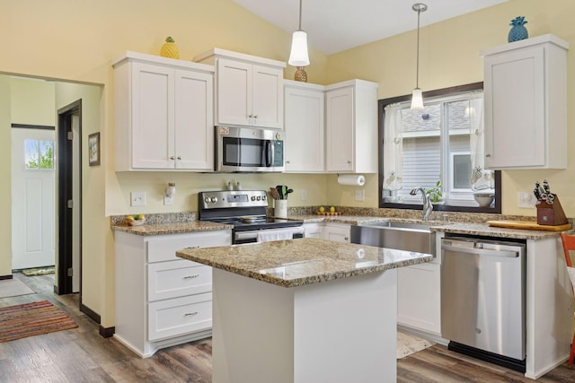 134 9th Ave NE, Isanti, MN 55040 - kitchen featuring appliances with stainless steel finishes, a sink, white cabinetry, and vaulted ceiling