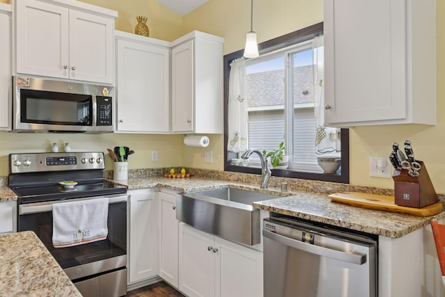 134 9th Ave NE, Isanti, MN 55040 - kitchen featuring stainless steel appliances, a sink, white cabinets, light stone countertops, and pendant lighting