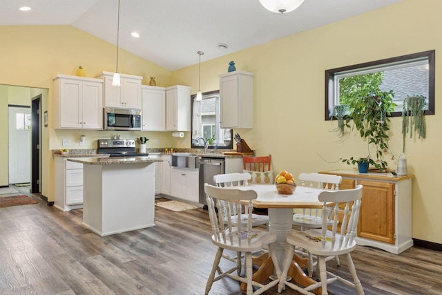 134 9th Ave NE, Isanti, MN 55040 - kitchen with appliances with stainless steel finishes, healthy amount of natural light, a center island, white cabinets, and vaulted ceiling