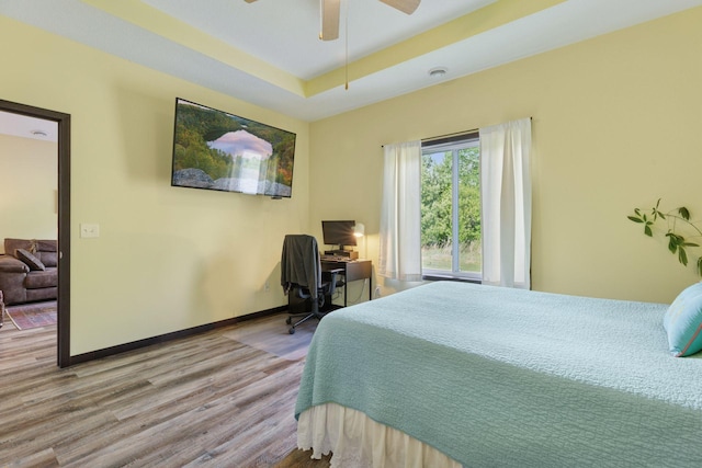 134 9th Ave NE, Isanti, MN 55040 - bedroom featuring wood finished floors, a desk, baseboards, and ceiling fan