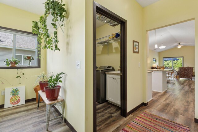 134 9th Ave NE, Isanti, MN 55040 - hallway featuring dark wood finished floors, washer and dryer, lofted ceiling, and baseboards