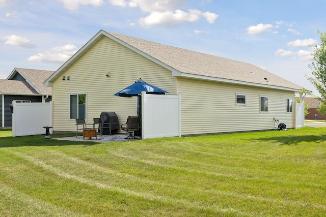 134 9th Ave NE, Isanti, MN 55040 - back of property featuring a patio area and a shingled roof