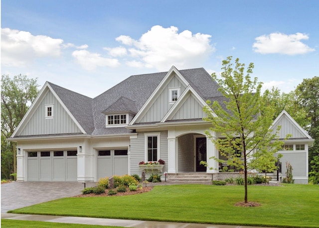677 Shawnee Woods Rd, Medina, MN 55340 - craftsman-style house with board and batten siding, a shingled roof, decorative driveway, and a front lawn