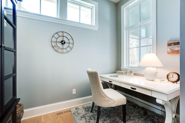 677 Shawnee Woods Rd, Medina, MN 55340 - home office featuring plenty of natural light, wood finished floors, and baseboards