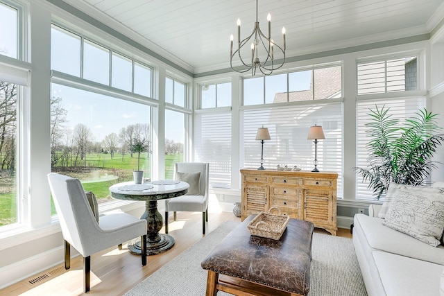 677 Shawnee Woods Rd, Medina, MN 55340 - sunroom / solarium with ornamental molding, healthy amount of natural light, wood finished floors, and a chandelier