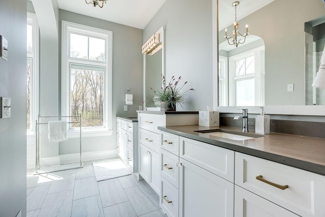 677 Shawnee Woods Rd, Medina, MN 55340 - full bath featuring vanity, healthy amount of natural light, and a chandelier