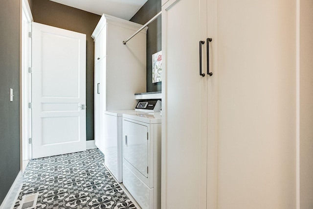 677 Shawnee Woods Rd, Medina, MN 55340 - laundry room with baseboards, separate washer and dryer, and cabinet space