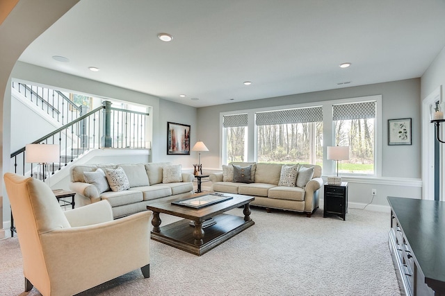 677 Shawnee Woods Rd, Medina, MN 55340 - carpeted living area with baseboards, stairs, and recessed lighting