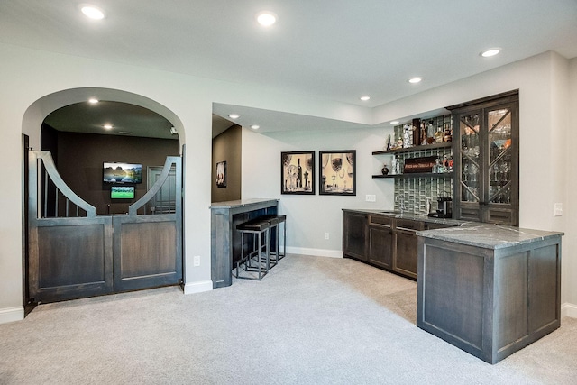 677 Shawnee Woods Rd, Medina, MN 55340 - indoor wet bar with carpet floors, baseboards, recessed lighting, and arched walkways