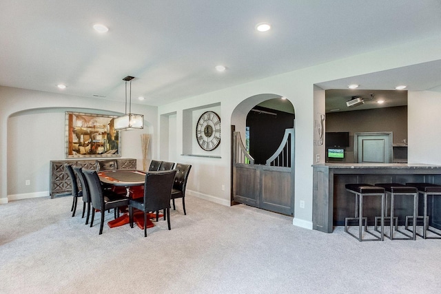 677 Shawnee Woods Rd, Medina, MN 55340 - dining room with carpet floors, arched walkways, recessed lighting, and baseboards
