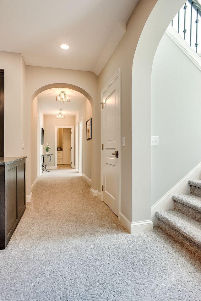 677 Shawnee Woods Rd, Medina, MN 55340 - corridor with carpet, stairway, baseboards, arched walkways, and recessed lighting