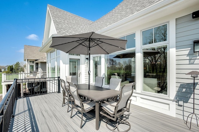 677 Shawnee Woods Rd, Medina, MN 55340 - wooden terrace with outdoor dining area