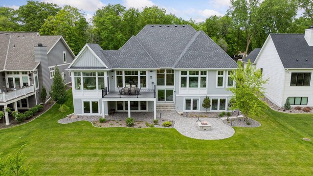677 Shawnee Woods Rd, Medina, MN 55340 - rear view of property featuring a patio area, a sunroom, a lawn, board and batten siding, and a deck