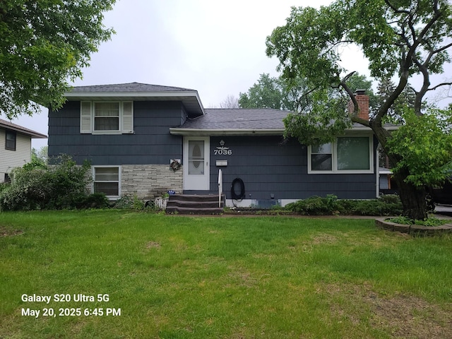 7036 Regent Ave N, Brooklyn Center, MN 55429 - tri-level home featuring a chimney, a front lawn, and roof with shingles