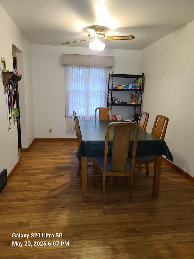 7036 Regent Ave N, Brooklyn Center, MN 55429 - dining space with a ceiling fan, wood finished floors, and baseboards