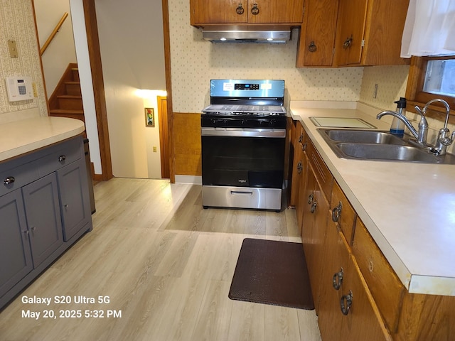 7036 Regent Ave N, Brooklyn Center, MN 55429 - kitchen with stainless steel range with gas cooktop, extractor fan, a sink, and light countertops