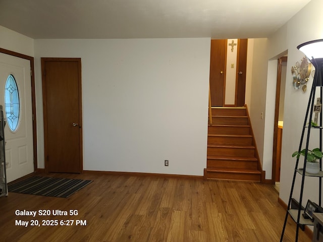 7036 Regent Ave N, Brooklyn Center, MN 55429 - foyer entrance with wood finished floors, stairway, and baseboards