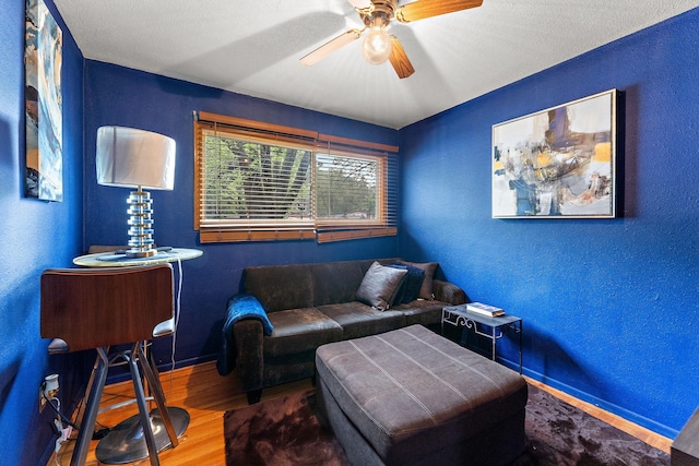 239 Buron Ln S, Saint Paul, MN 55075 - sitting room featuring wood finished floors, baseboards, a textured wall, and a ceiling fan