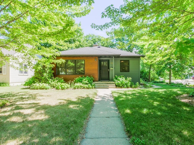 1423 Cedar St, Alexandria, MN 56308 - view of front facade with a front yard and a chimney