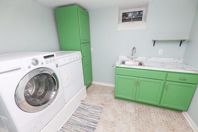 1423 Cedar St, Alexandria, MN 56308 - laundry area with washer and dryer, cabinet space, light tile patterned flooring, and baseboards