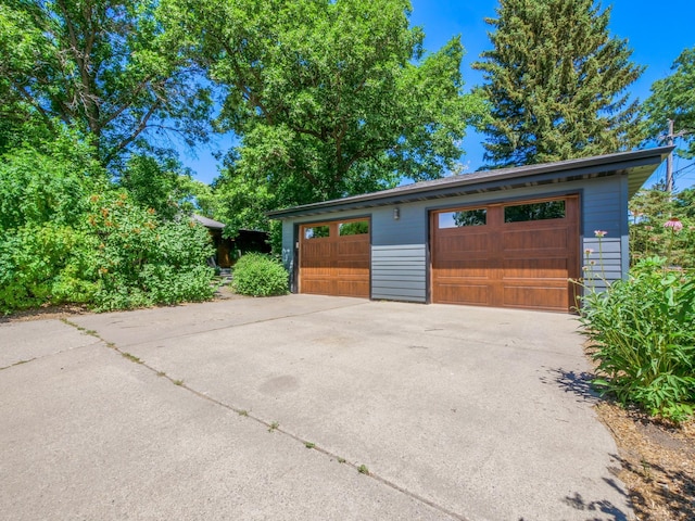 1423 Cedar St, Alexandria, MN 56308 - view of front of home featuring an outdoor structure and a garage