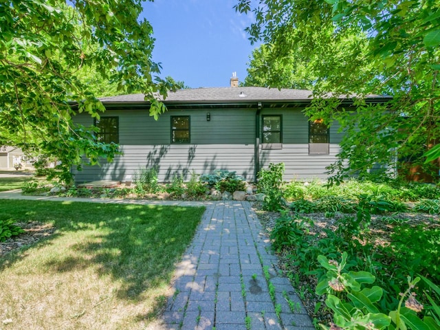 1423 Cedar St, Alexandria, MN 56308 - rear view of house with a yard and a chimney