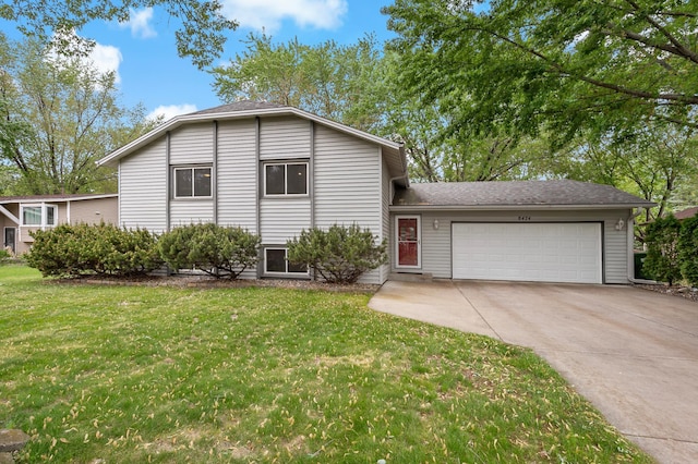 8474 Sunnyside Rd, Mounds View, MN 55112 - split level home with an attached garage, driveway, a front yard, and a shingled roof