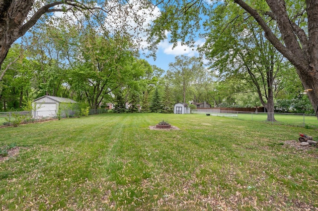 8474 Sunnyside Rd, Mounds View, MN 55112 - view of yard with an outdoor fire pit and view of scattered trees