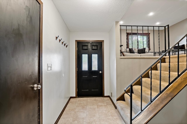 8474 Sunnyside Rd, Mounds View, MN 55112 - foyer featuring stairway, baseboards, a textured ceiling, and light tile patterned flooring