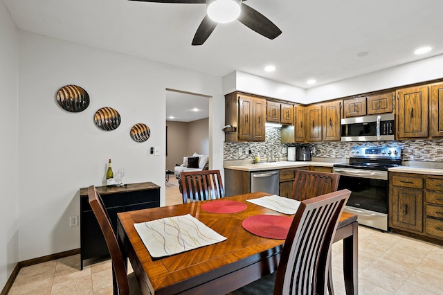 8474 Sunnyside Rd, Mounds View, MN 55112 - kitchen with stainless steel appliances, decorative backsplash, light countertops, and recessed lighting